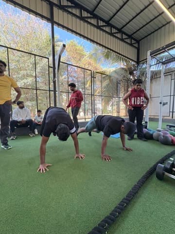 Coached small-group training session on the turf at FOMO Training