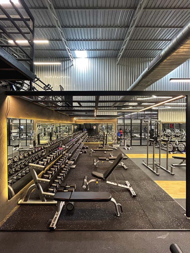 Full dumbbell rack and mirrored free-weights area at FOMO Training