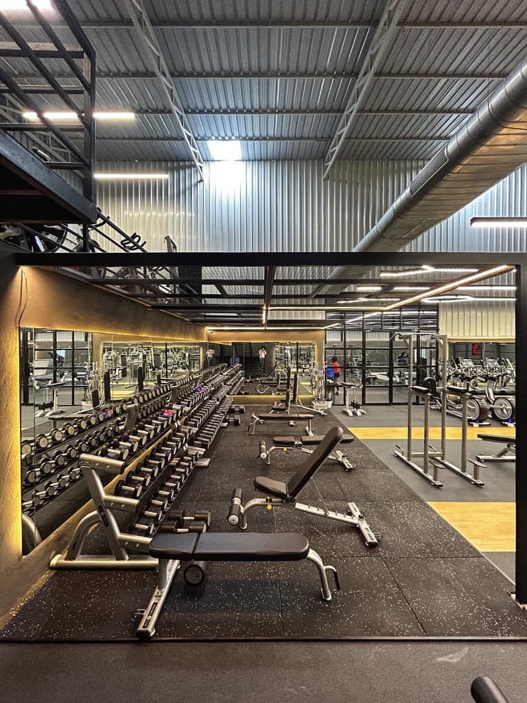 Full dumbbell rack and mirrored free-weights area at FOMO Training