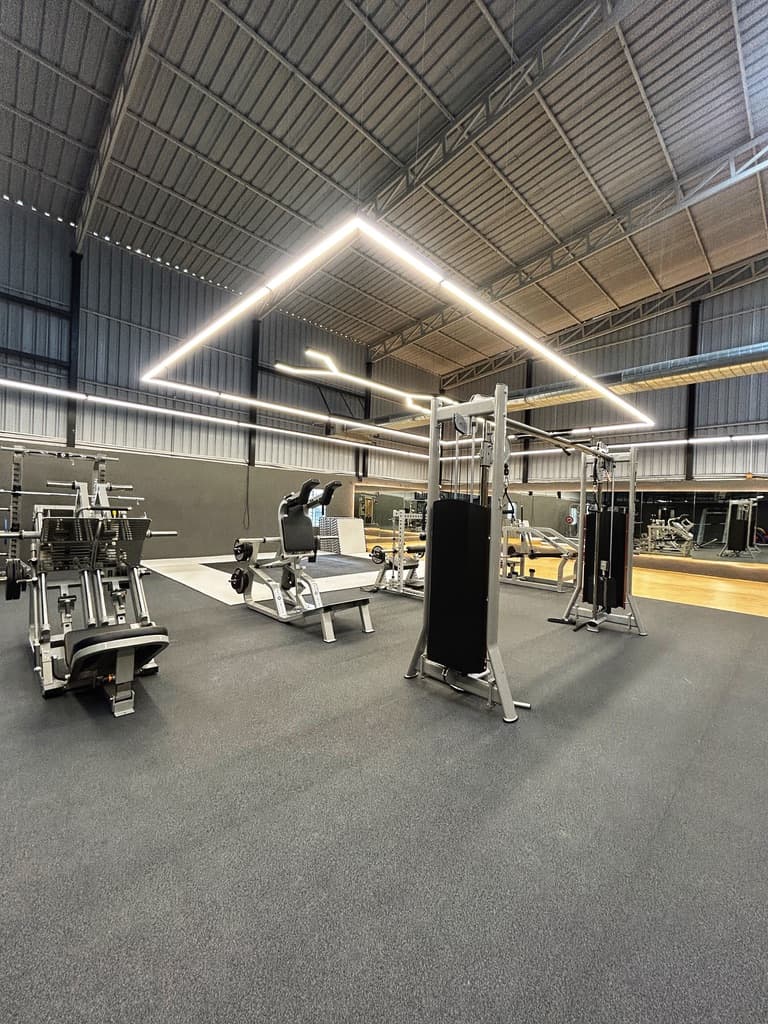 Strength training machines and lifting platform at FOMO Training, Carmelaram
